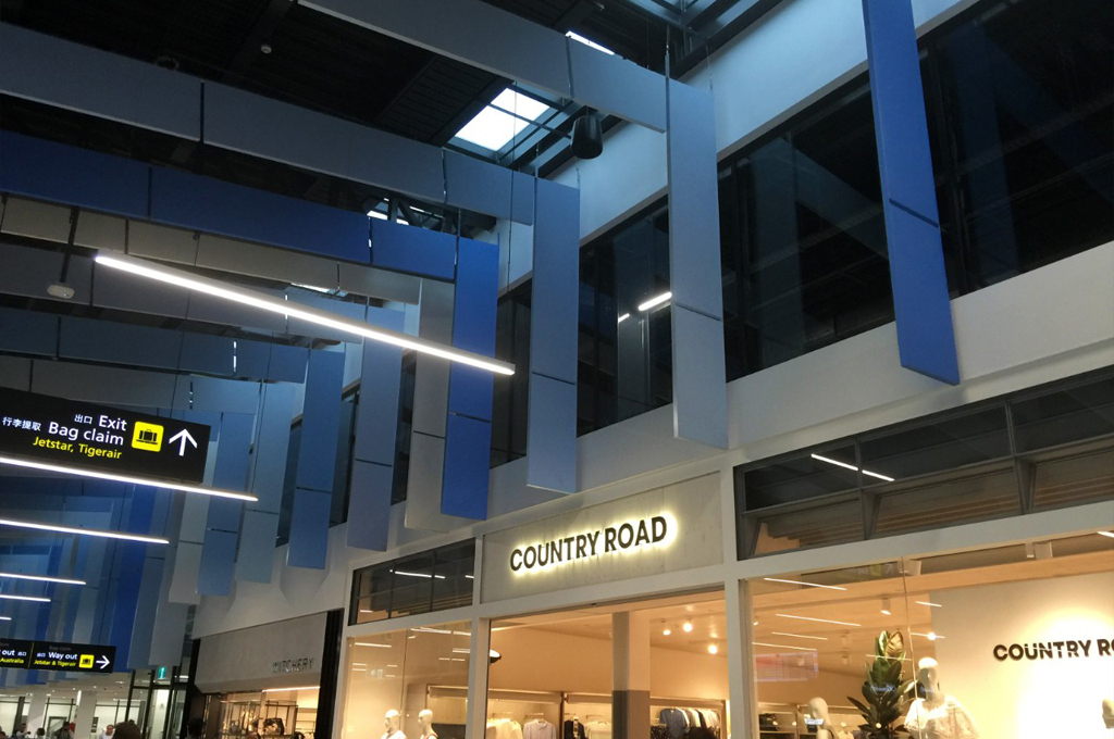 Suspended acoustic baffles in creating a bold ceiling pattern in a modern interior