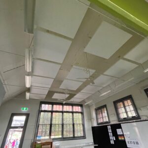 Acoustic Panels for classroom, White acoustic ceiling panels suspended to reduce reverberation in a large classroom area.