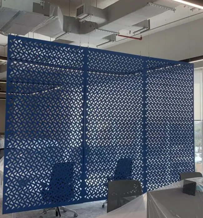 Blue geometric Decrasound acoustic hanging screen installed in an open office space at the Nokia project.