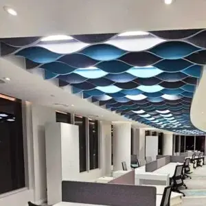 Custom Decrasound acoustic baffles in blue tones installed on a ceiling to control sound and add visual movement.