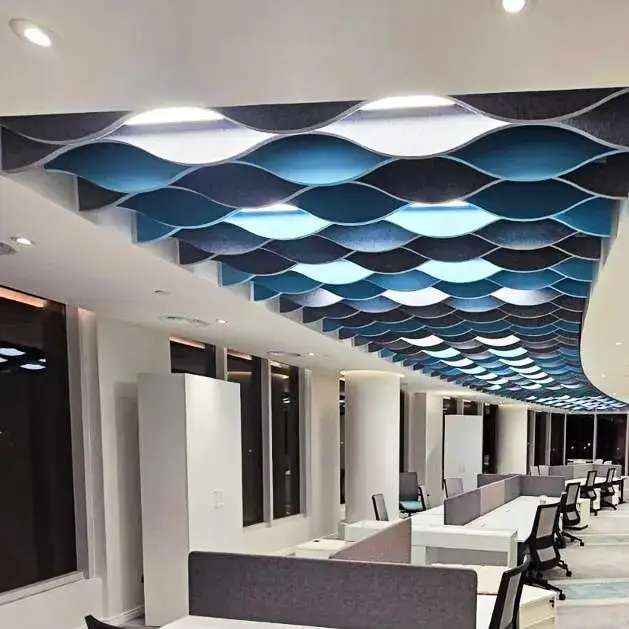 Custom Decrasound acoustic baffles in blue tones installed on a ceiling to control sound and add visual movement.