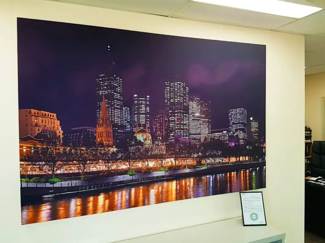Serenity Acoustic Art Panel featuring a night view of Melbourne city lights, installed in a modern office interior.