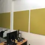 SerenityLite fabric acoustic wall panels in soft yellow, installed in an office meeting room to improve sound clarity and reduce reverberation.