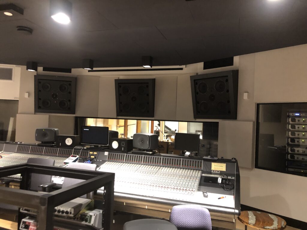 Professional recording studio control room featuring acoustic wall and ceiling panels designed to improve sound accuracy and reduce unwanted reflections